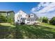Large, green back yard features paver patio and the back of the house at 12942 Blakemore Ave, Huntersville, NC 28078
