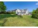 Large, green back yard features paver patio and the back of the house at 12942 Blakemore Ave, Huntersville, NC 28078