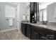 The bathroom features double sinks, a granite countertop, and dark wood cabinets at 12942 Blakemore Ave, Huntersville, NC 28078