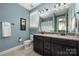 Well-lit bathroom features double vanity, tile floors, and decorative accents at 12942 Blakemore Ave, Huntersville, NC 28078