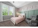 A charming bedroom features a cozy chair, natural light, and playful decor at 12942 Blakemore Ave, Huntersville, NC 28078