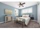 A serene bedroom with blue walls and large windows boasts ample natural light at 12942 Blakemore Ave, Huntersville, NC 28078