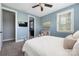 Cozy bedroom with soft blue walls and a doorway to the ensuite bath at 12942 Blakemore Ave, Huntersville, NC 28078