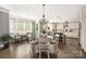 Bright dining room with modern chandelier, hardwood flooring and large window overlooking lush yard at 12942 Blakemore Ave, Huntersville, NC 28078