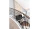 Modern railing looks down on a fireplace with stone veneer and hardwood floors at 12942 Blakemore Ave, Huntersville, NC 28078
