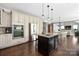 Spacious kitchen with stainless steel appliances, granite counters, and a view into the dining area at 12942 Blakemore Ave, Huntersville, NC 28078