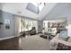 Bright living room with a vaulted ceiling, large windows, and a view into the kitchen at 12942 Blakemore Ave, Huntersville, NC 28078