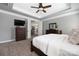 The main bedroom has a tray ceiling, ceiling fan, and dark wood furniture set at 12942 Blakemore Ave, Huntersville, NC 28078
