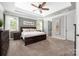 This main bedroom features a large window, neutral walls, and a dark wood furniture set at 12942 Blakemore Ave, Huntersville, NC 28078