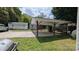 Spacious backyard featuring a covered patio, two sheds, and green grass, offering ample outdoor space at 1306 Brantley Rd, Kannapolis, NC 28083