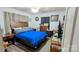 Cozy bedroom with wood-look flooring, ceiling fan, dresser, area rug, and queen bed with a blue quilt at 1306 Brantley Rd, Kannapolis, NC 28083