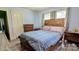 Charming bedroom featuring a wooden bed frame, neutral curtains, and light blue wall paint at 1306 Brantley Rd, Kannapolis, NC 28083