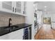 Wet bar with wine fridge, undermount sink, tile backsplash, and stainless steel appliances at 13453 Portside Ln, Lancaster, SC 29720