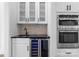 Wet bar with wine fridge, undermount sink, tile backsplash, and stainless steel appliances at 13453 Portside Ln, Lancaster, SC 29720