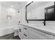 Bathroom featuring marble tiled wall over tub, black faucet, and white dual sink vanity at 13453 Portside Ln, Lancaster, SC 29720