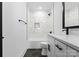 Well lit bathroom with white marbled backsplash, toilet, and vanity with black modern fixtures at 13453 Portside Ln, Lancaster, SC 29720