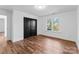 Bedroom featuring hardwood floors, window, and closet with black doors at 13453 Portside Ln, Lancaster, SC 29720