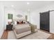 Bright bedroom featuring a barn door, hardwood floors, and stylish neutral decor at 13453 Portside Ln, Lancaster, SC 29720