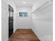 Walk-in closet with wood floors, natural light, and wire shelving for organized storage at 13453 Portside Ln, Lancaster, SC 29720