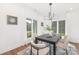 Bright dining room with modern lighting, dark table, neutral chairs, and large windows for natural light at 13453 Portside Ln, Lancaster, SC 29720