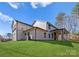 A side view of a two-story home that has a covered patio, open-air porch, and lush lawn at 13453 Portside Ln, Lancaster, SC 29720