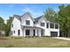 Stunning two-story home with a modern farmhouse design, black trim windows, and a lush front lawn at 13453 Portside Ln, Lancaster, SC 29720