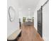 Elegant hallway featuring hardwood floors, recessed lighting, modern mirror, and stylish barn door access at 13453 Portside Ln, Lancaster, SC 29720