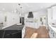 Bright, modern kitchen with black island, white cabinetry, stainless steel appliances, and stylish pendant lighting at 13453 Portside Ln, Lancaster, SC 29720