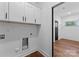 A well-equipped laundry room with white cabinets and space for washer and dryer at 13453 Portside Ln, Lancaster, SC 29720