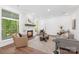 Cozy living room with a stone fireplace, hardwood floors, natural lighting, and modern decor at 13453 Portside Ln, Lancaster, SC 29720