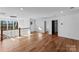 Spacious living room with hardwood flooring, modern light fixture, and staircase with wood and iron railing at 13453 Portside Ln, Lancaster, SC 29720