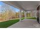 An outdoor patio with white trim columns and a green yard that looks out to a wooded area at 13453 Portside Ln, Lancaster, SC 29720
