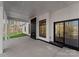 Outdoor patio with a fireplace, white trim, and sliding glass doors with a view of the yard and lake at 13453 Portside Ln, Lancaster, SC 29720