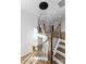 Staircase with wooden steps, black iron railing, and a modern chandelier hanging above at 13453 Portside Ln, Lancaster, SC 29720