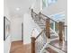 Elegant staircase with dark wood railings, natural lighting, and modern design elements at 13453 Portside Ln, Lancaster, SC 29720