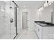 Elegant bathroom with dual sinks, modern lighting, and glass-enclosed shower at 13748 Roderick Dr # 174, Huntersville, NC 28078