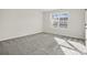A vacant bedroom featuring plush carpet and a sunny window at 13748 Roderick Dr # 174, Huntersville, NC 28078