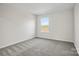 Bedroom showcasing neutral carpet and a sunlit window at 13748 Roderick Dr # 174, Huntersville, NC 28078