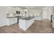 A modern kitchen with a large island, stainless steel appliances, and white cabinets at 13748 Roderick Dr # 174, Huntersville, NC 28078