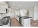 Bright, open kitchen features an island with dark countertops and stainless steel appliances at 13748 Roderick Dr # 174, Huntersville, NC 28078