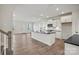 Open-concept kitchen featuring an island with a sink and stainless steel appliances at 13748 Roderick Dr # 174, Huntersville, NC 28078