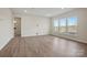 A bright living room features light wood floors, bright white walls, and large windows at 13748 Roderick Dr # 174, Huntersville, NC 28078