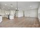 Open floor plan featuring a kitchen with an island and light-filled living room at 13748 Roderick Dr # 174, Huntersville, NC 28078