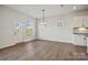 Living room features light wood floors, white walls and trim and a modern chandelier at 13748 Roderick Dr # 174, Huntersville, NC 28078