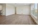 Living room with light wood floors, bright white walls and a large window at 13748 Roderick Dr # 174, Huntersville, NC 28078