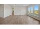 A bright living room features light wood floors, bright white walls, and large windows at 13748 Roderick Dr # 174, Huntersville, NC 28078