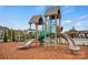 Community playground with two slides and climbing equipment on a wood chip safety surface at 13748 Roderick Dr # 174, Huntersville, NC 28078