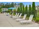 Relaxing poolside with rows of white loungers for residents to enjoy the sunny outdoors at 13748 Roderick Dr # 174, Huntersville, NC 28078