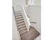 Hardwood stairs with white risers and dark handrail offer modern style at 13748 Roderick Dr # 174, Huntersville, NC 28078