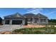New construction single-story home featuring a stone facade, attached two-car garage, and craftsman-style details at 1469 Mocksville Hwy # 21, Statesville, NC 28625